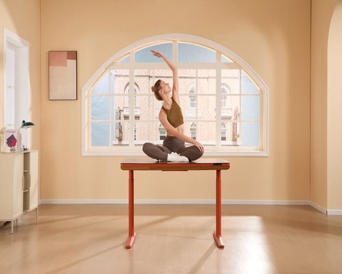 Person stretching arms at home office desk