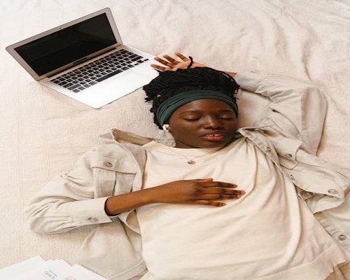 Person resting eyes and putting laptop away